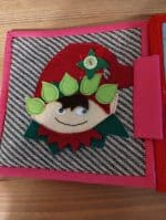 Jucarie educativa din fetru și material textil, decorată cu elemente textile și ochi mobili pentru copii.