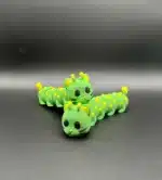 Caterincă din plastic verde cu puncte galbene, model jucărie educativă pentru copii și colecție de jucării și hobby-uri.